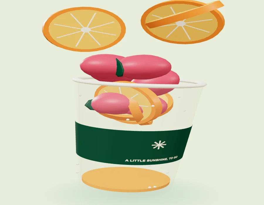 Stage one: orange and berry pieces falling towards an empty smoothie cup.
